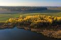 Aerial view of road between autumn forest and green fields. Beautiful landscape of highway, green fields, trees with green and Royalty Free Stock Photo