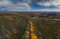 Aerial view of road in beautiful autumn altai forest Royalty Free Stock Photo