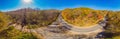 Aerial view of road in beautiful autumn forest at sunset. Beautiful landscape with empty rural road, trees with red and Royalty Free Stock Photo