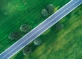 Aerial view of road through beautiful green field Royalty Free Stock Photo