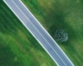 Aerial view of road through beautiful green field Royalty Free Stock Photo