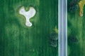 Aerial view of road through beautiful green field Royalty Free Stock Photo