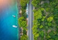 Aerial view of road in beautiful green forest and boats and yacht Royalty Free Stock Photo
