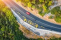 Aerial view of road in beautiful green forest at sunset in summer Royalty Free Stock Photo