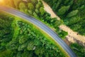 Aerial view of road in beautiful green forest at sunset in summer Royalty Free Stock Photo