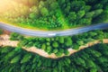 Aerial view of road in beautiful green forest at sunset in summer Royalty Free Stock Photo