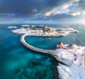Aerial view of road, bridges, snowy islands, rorbu, sea at sunset Royalty Free Stock Photo