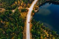 Aerial view of road with car through fall woods with green and yellow trees in Finland Royalty Free Stock Photo