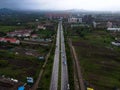 Aerial view of a road with cars with industrial buildings in the background