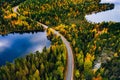 Aerial view of road and colorful autumn  forest with mountains and blue lakes in Finland Royalty Free Stock Photo