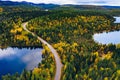 Aerial view of road and colorful autumn  forest with mountains and blue lakes in Finland Royalty Free Stock Photo