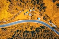Aerial view of road in colorful orange forest at sunset in autumn Royalty Free Stock Photo