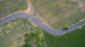 Aerial view road curve construction. Aerial above view of a rural landscape with a curvy road running through. Aerial view of curv