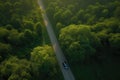 Aerial view road and forest. Road going through forest with car view from above. Generative AI Royalty Free Stock Photo