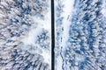 Aerial view on the road and forest at the winter time. Natural winter landscape from air. Forest under snow at the winter time. Royalty Free Stock Photo