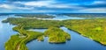 Aerial view of road between green summer forest and blue lake in Finland Royalty Free Stock Photo