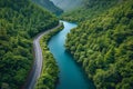 Aerial view of road with green woods by blue lakes water, beautiful view