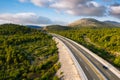 Aerial view on road. Highway through mountain valley. View from a drone. Natural landscape in summer time from air. Travel and vac Royalty Free Stock Photo