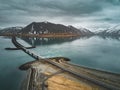 Aerial view of road 1 in iceland with bridge over the sea in Snaefellsnes peninsula with clouds, water and mountain in