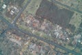 Road intersection in a ghost town surrounded by burnt foundations and rubble of destroyed homes aerial view illustrating Royalty Free Stock Photo