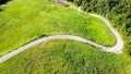 Aerial view of a road between meadows Royalty Free Stock Photo