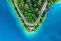 Aerial view of road near blue lake, forest at sunrise in summer Royalty Free Stock Photo