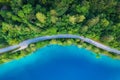 Aerial view of road near blue lake, forest at sunrise in summer Royalty Free Stock Photo