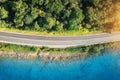 Aerial view of road near blue sea, forest at sunset in summer Royalty Free Stock Photo