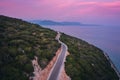 Aerial view of road near blue sea, forest at sunset in summer Royalty Free Stock Photo