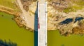 Aerial view on road over river under construction, building the bridge Royalty Free Stock Photo