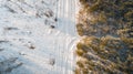 Aerial view of road passing through the snow-covered winter forest. Top view Royalty Free Stock Photo