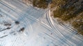 Aerial view of road passing through the snow-covered winter forest. Top view Royalty Free Stock Photo