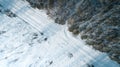 Aerial view of road passing through the snow-covered winter forest. Top view Royalty Free Stock Photo