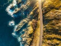 Aerial view of road, rocky sea coast with waves at sunset Royalty Free Stock Photo
