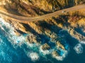 Aerial view of road, rocky sea coast with waves at sunset Royalty Free Stock Photo