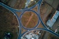 Aerial view of road roundabout intersection with fast moving heavy traffic at night. Top view of urban circular Royalty Free Stock Photo
