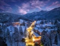 Aerial view of road, snowy mountains, street lights at night Royalty Free Stock Photo