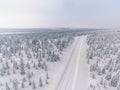 Aerial view of the road in the winter snow forest in Finland Royalty Free Stock Photo