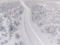 Aerial view of the road in the winter snow forest in Finland Royalty Free Stock Photo