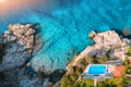 Aerial view of rocky beach, pool, green trees and blue sea Royalty Free Stock Photo