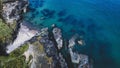 Aerial view of rocky beach shoreline, with stunning turquoise water. Royalty Free Stock Photo