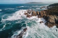 an aerial view of a rocky coastline with waves crashing against the rocks and the ocean in the distance with a small island in Royalty Free Stock Photo