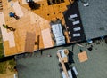 Roof construction repairman on a residential apartment with new roof shingle being applied