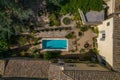 Aerial view from the roof of the modern villa of a swimming pool with a garden on a sunny weather Royalty Free Stock Photo