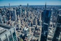 An aerial view of the rooftops of buildings and bustling streets of New York