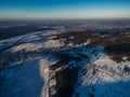 aerial view of rooftops of houses in village and beautiful snow-covered fields