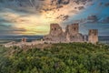 Aerial view of ruined Gothic Csesznek castle with colorful dramatic sunset