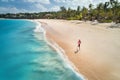 Aerial view of the running young woman on the sandy beach Royalty Free Stock Photo