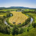 Aerial view of a rural farmstead surrounded by cultivated agricultural fields in St-Donat, Quebec.