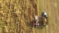 Aerial View Of Rural Landscape. Combine Harvester And Tractor Working In Corn Field. Collects Dry Corn Plants Royalty Free Stock Photo